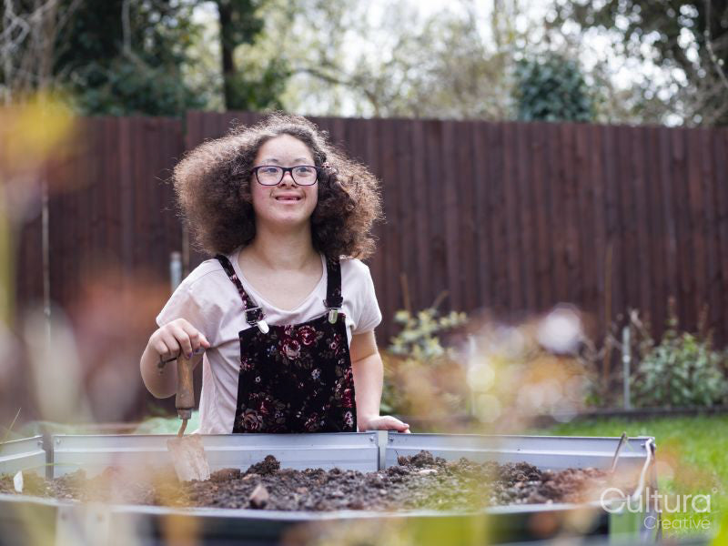Girl doing gardening work in backyard
