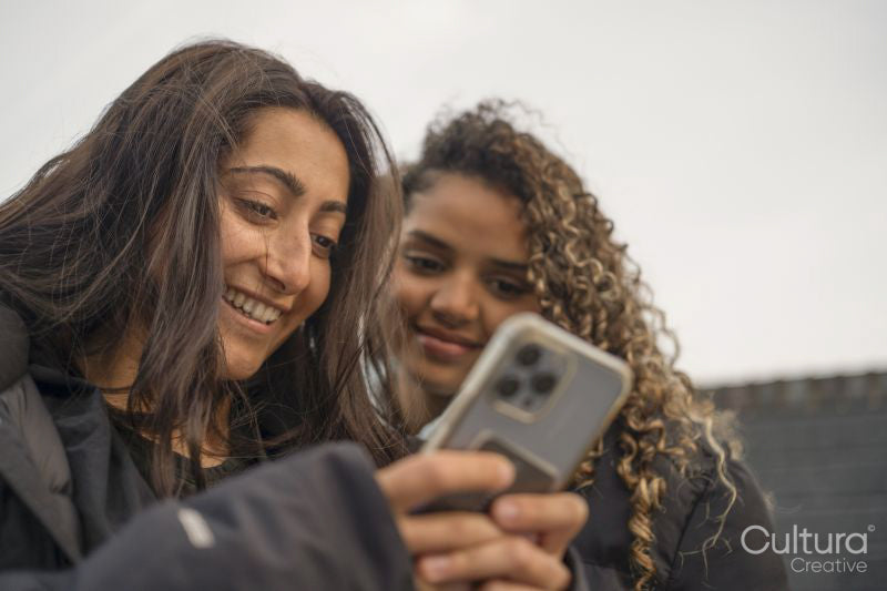 Two young women looking at smartphone