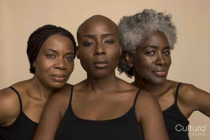 Studio portrait of three confident women in black tops
