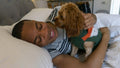 Man lying in bed with dog