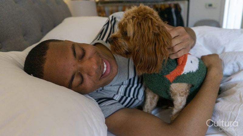Man lying in bed with dog