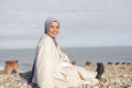 Portrait of Muslim woman sitting on beach