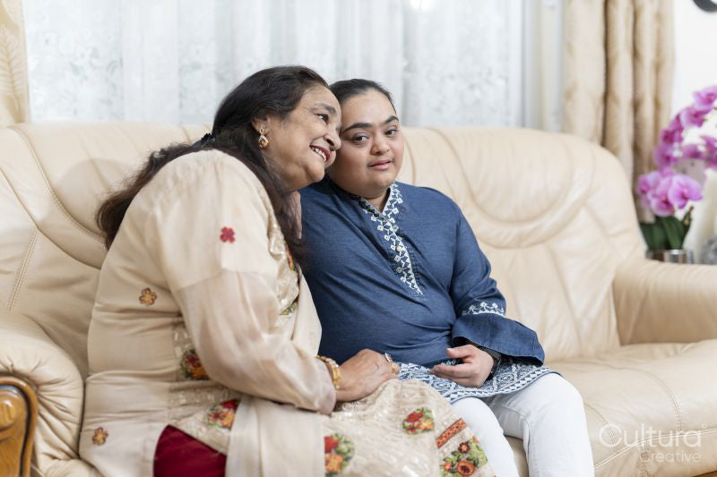 Portrait of grandmother and granddaughter in living room