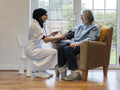 Doctor measuring blood pressure to female patient