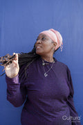 Portrait of beautiful woman with dreadlocks wearing a headscarf