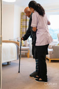 Nurse helping senior man in his room at nursing home