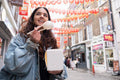 Young woman eating steamed bun in Chinatown