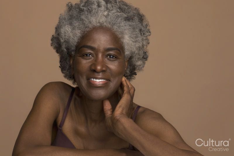 Studio portrait of smiling senior woman