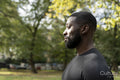 Profile of athletic man standing in park