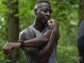 Man stretching after workout in forest