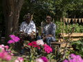 Smiling mature couple relaxing in garden in summer