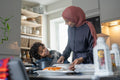 Mother and son preparing meal at home