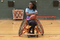 Teenage girl in wheelchair on basketball court