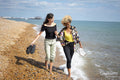 Female couple walking on beach