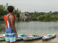 Young man looking at lake before paddleboarding