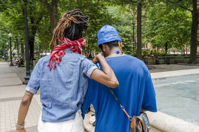 Rear view of young couple walking in park