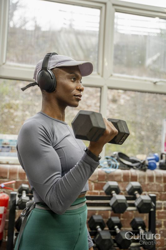 Woman exercising with dumbbells at gym