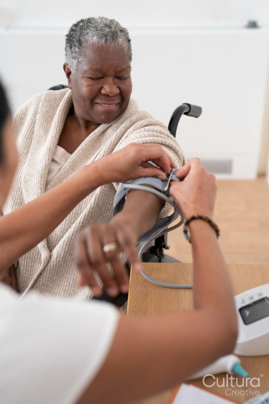Female doctor measuring senior patients blood pressure