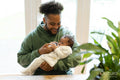 Father feeding baby daughter at home