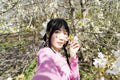 Portrait of young woman among tree blossom