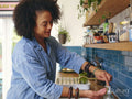 Woman washing hands in kitchen