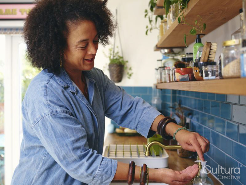 Woman washing hands in kitchen