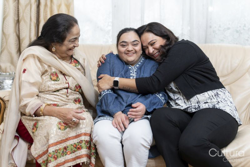 Family portrait with a young woman with down syndrome smiling at home