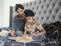 Mother and son reading book in bed