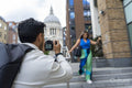 United Kingdom, London, Man taking pictures of woman in street