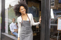 Smiling cafe owner at doorway