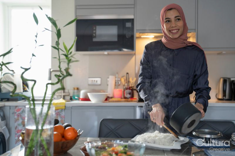Woman in hijab preparing meal at home