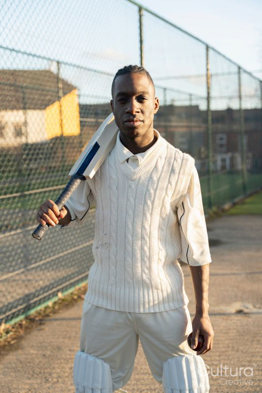 Portrait of cricketer standing on outdoors sports court