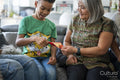 Family gathered in living room, sharing red envelopes