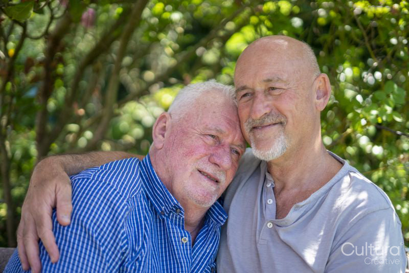 Senior male couple relaxing in garden
