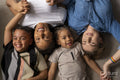 Portrait of mothers and sons cuddling on floor
