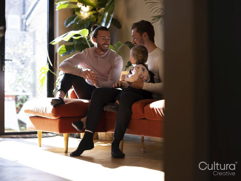 couple playing with baby daughter in living room