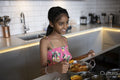 Smiling girl cooking in kitchen