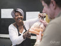 Volunteer giving man vegetables in community food center