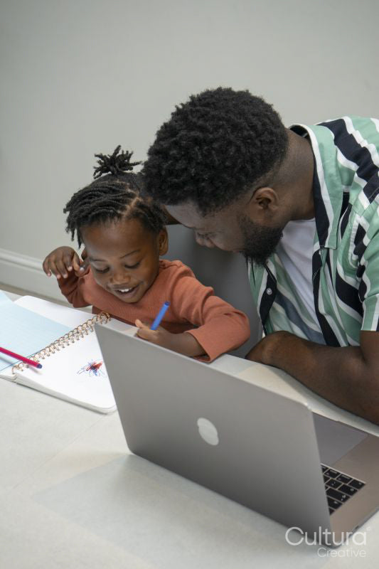 Father and daughter drawing together in notepad