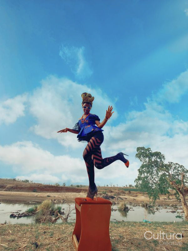 Fashion shot of young woman by river