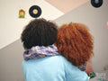 Mother and daughter embracing,rear view