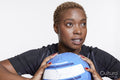 Studio portrait of female soccer player with ball