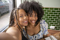 Portrait of smiling friends at restaurant table