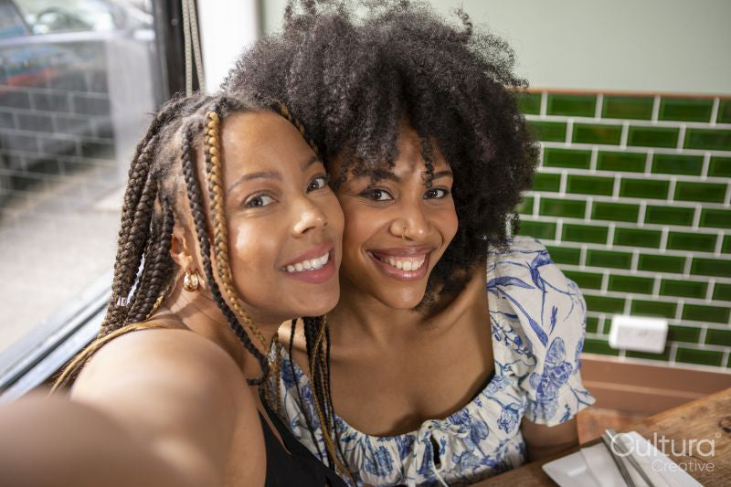 Portrait of smiling friends at restaurant table