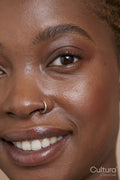 Close-up of smiling woman with nose ring