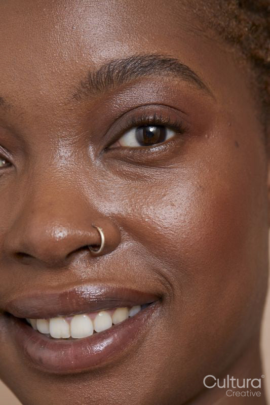 Close-up of smiling woman with nose ring