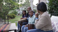 Family with children playing drums on patio