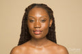Studio portrait of smiling woman with braided hair
