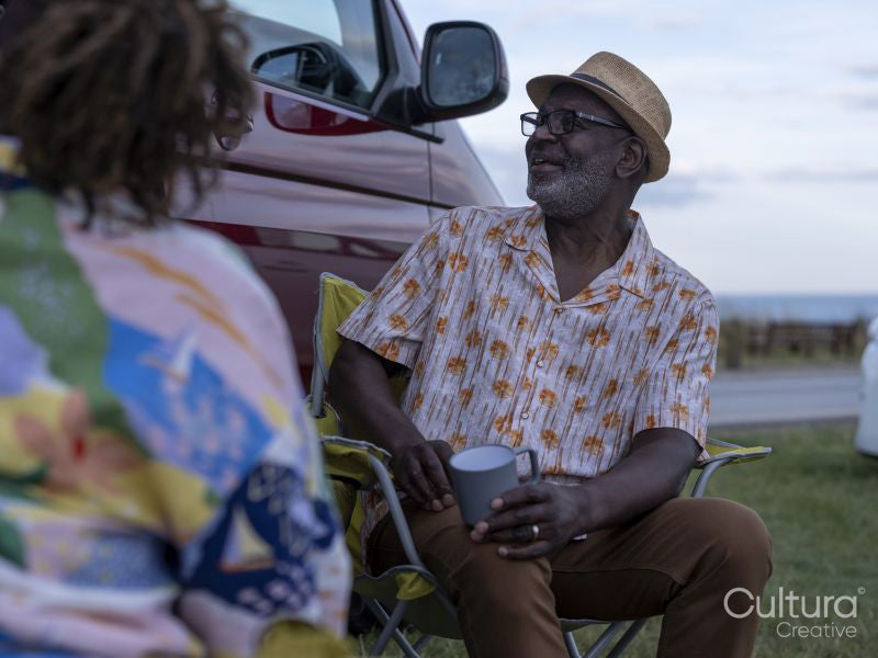 Senior couple camping in camper van