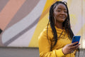South Yorkshire, Portrait of woman with braided hair holding smart phone